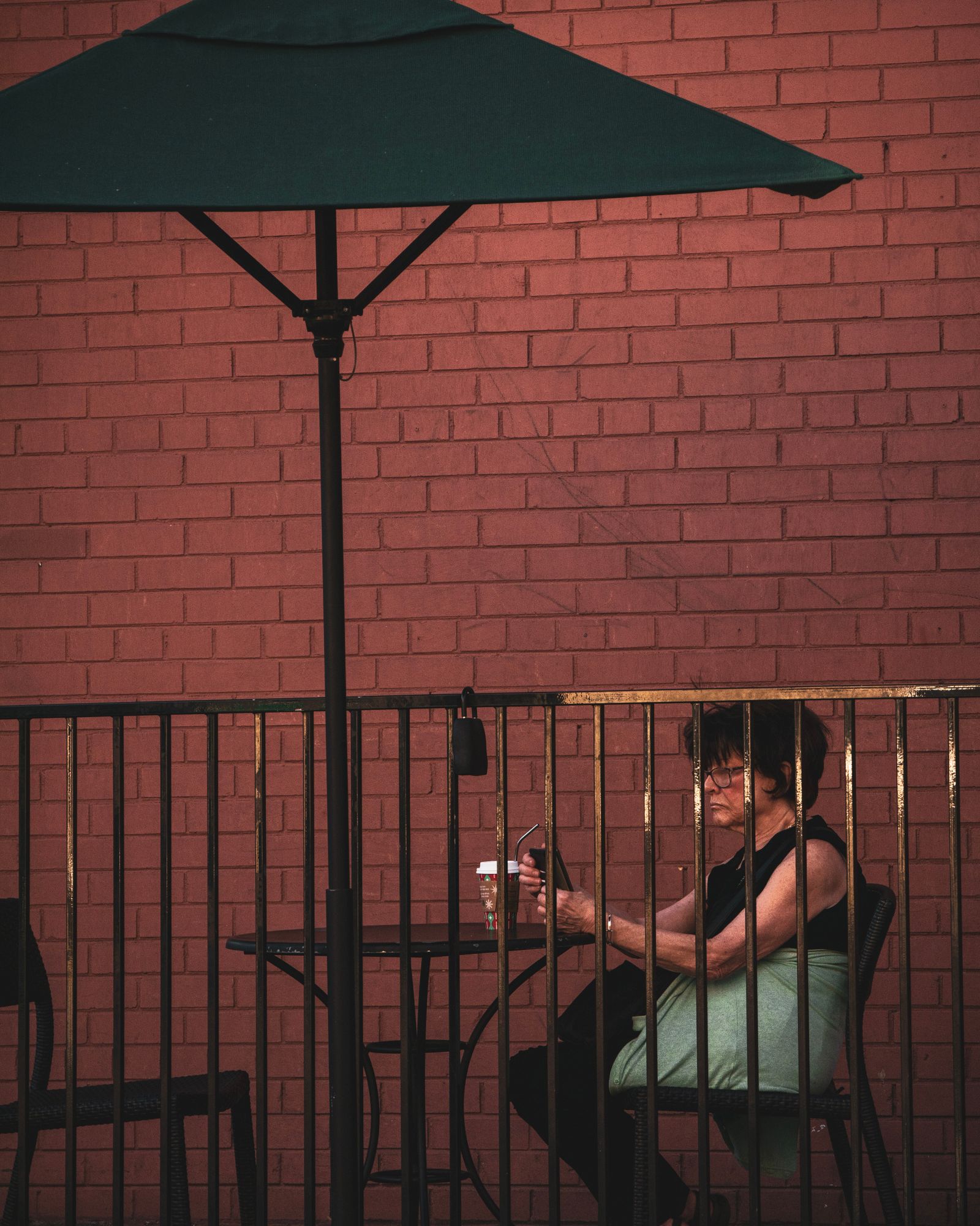 A customer checking her phone at a café table, the kind of moment Café Nejma's assistant is built for